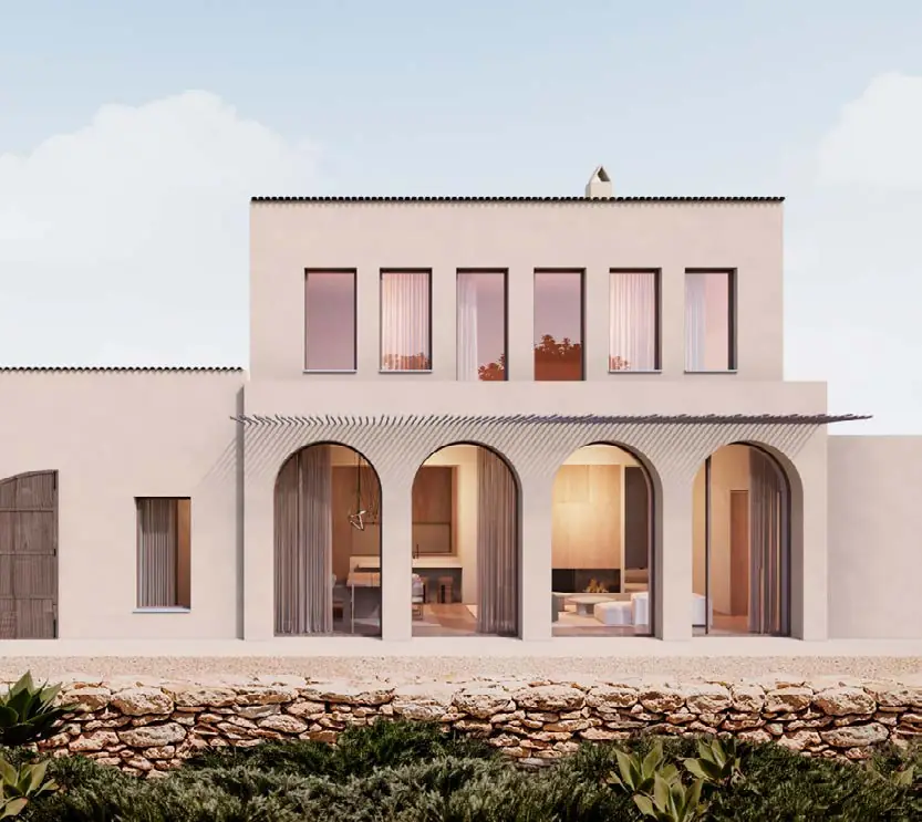 Fachada rosada de la vivienda de Alella con arcos en planta baja sobre un muro de piedra seca