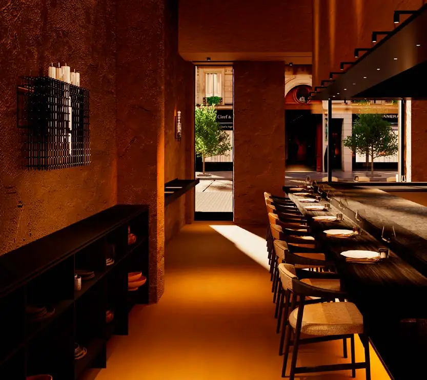 Interior estrecho de restaurante con paredes de textura terrosa, barra y luz cálida