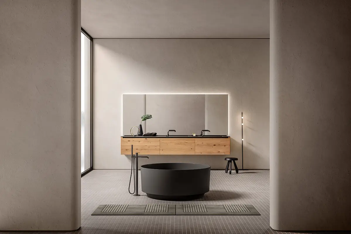 Baño con mueble de lavabo suspendido de madera de roble y encimera oscura, espejo iluminado y bañera exenta redonda negra