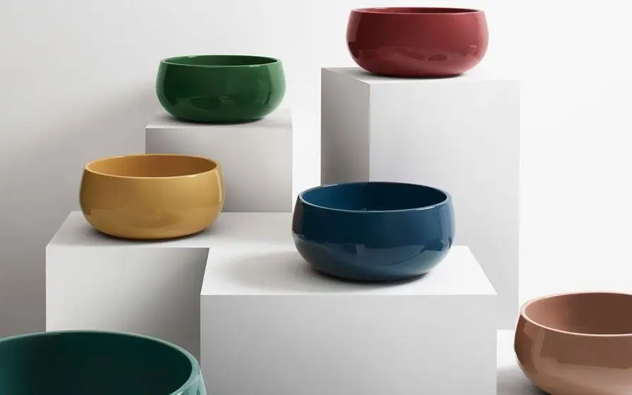 Seis lavabos de apoyo redondos esmaltados en verde, rojo, amarillo, azul, verde azulado y rosa sobre pedestales blancos