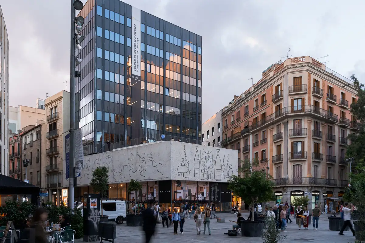 Fachada de la sede del COAC en la plaça Nova de Barcelona, con el friso esgrafiado de Picasso, al atardecer.