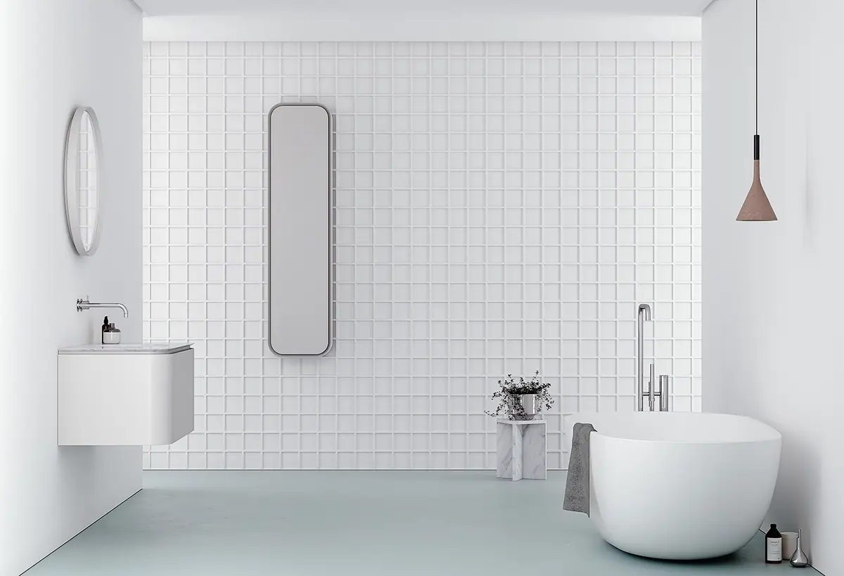Baño blanco con mueble suspendido de laterales redondeados, espejo redondo, espejo vertical y bañera exenta