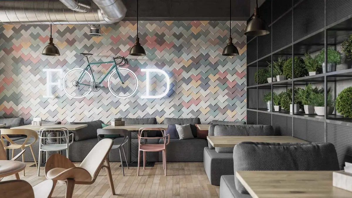 Pared de un restaurante revestida con piezas rectangulares de varios colores colocadas en espiga, con una bicicleta y letras luminosas