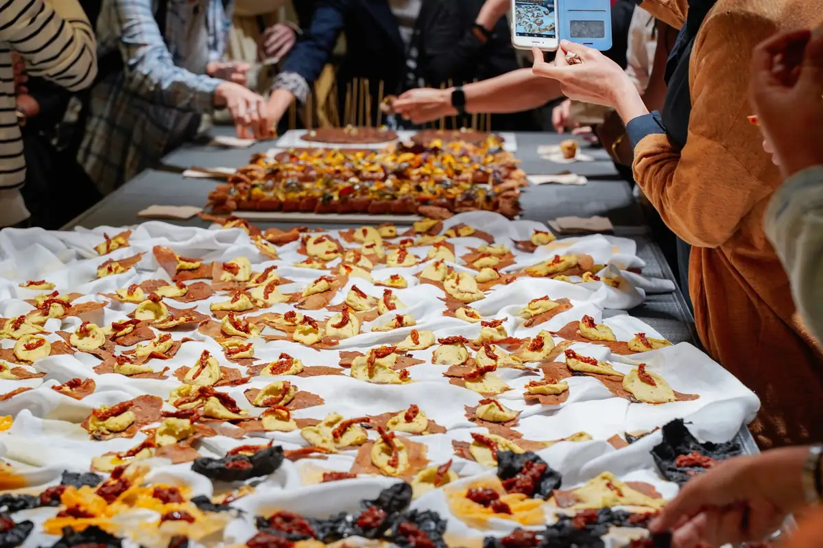 Asistentes se sirven de una mesa llena de bocados del Eco-Picnic